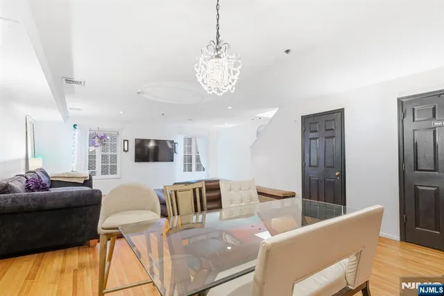 a living room with furniture and a chandelier