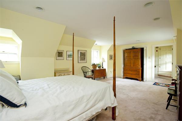 161 Main Street Hingham, MA 02043 - Photo 13 of 30 a bedroom with a bed a table and painting on the wall