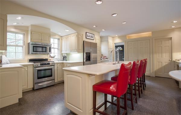 161 Main Street Hingham, MA 02043 - Photo 9 of 30 a kitchen with stainless steel appliances kitchen island granite countertop a dining table and chairs