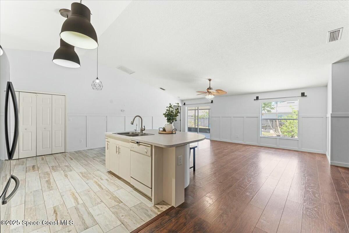 194 Saybrook Road Southwest Palm Bay, FL 32908 - Photo 11 of 35 a kitchen with a sink and wooden floor