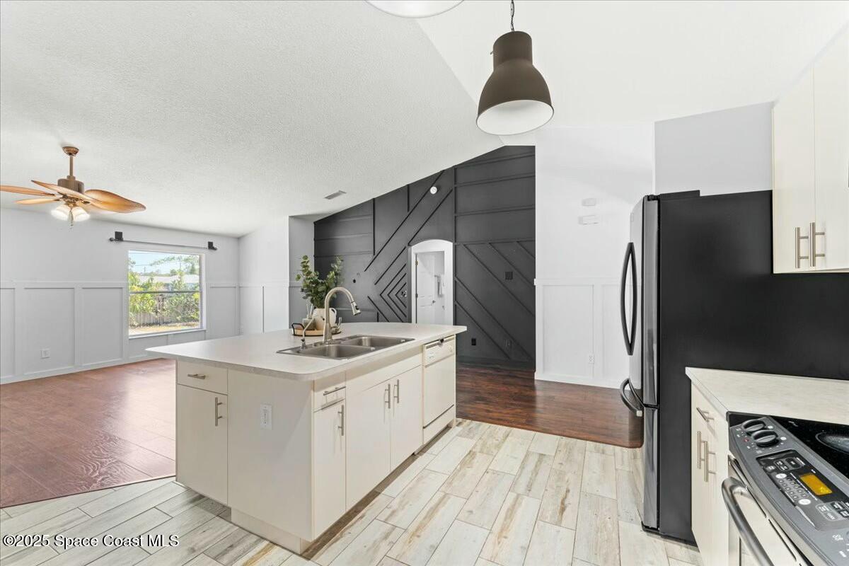194 Saybrook Road Southwest Palm Bay, FL 32908 - Photo 13 of 35 a kitchen with a sink stove and refrigerator