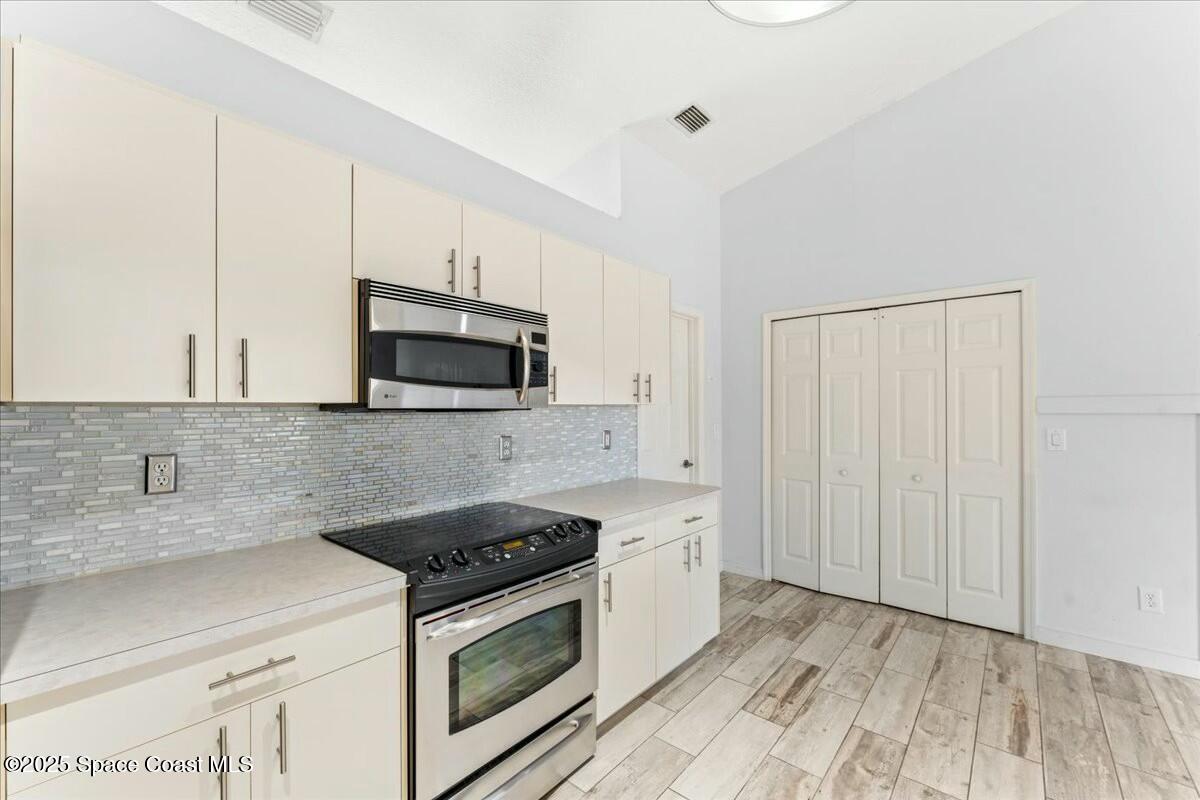 194 Saybrook Road Southwest Palm Bay, FL 32908 - Photo 15 of 35 a kitchen with granite countertop a stove and a sink
