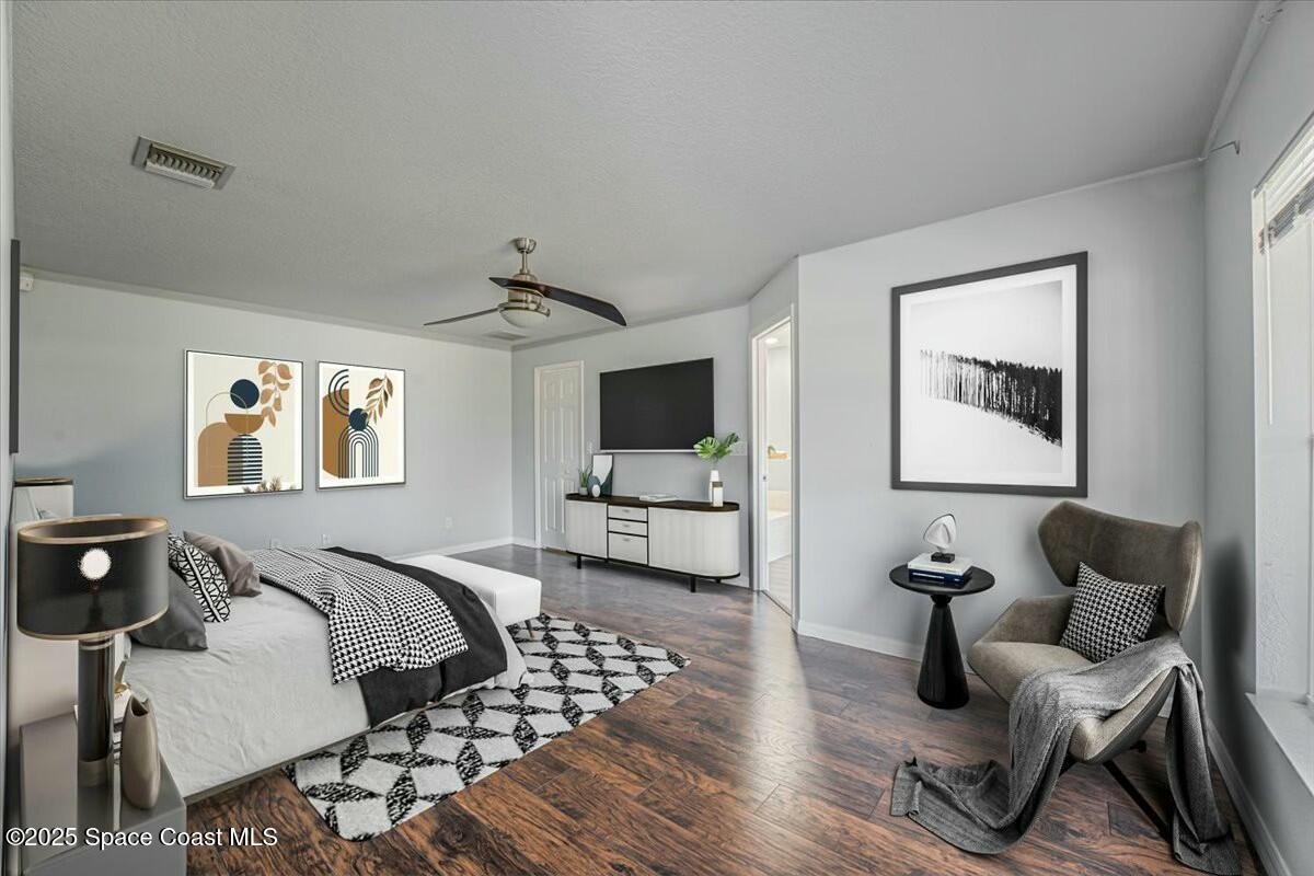 194 Saybrook Road Southwest Palm Bay, FL 32908 - Photo 22 of 35 a bedroom with furniture and a flat screen tv