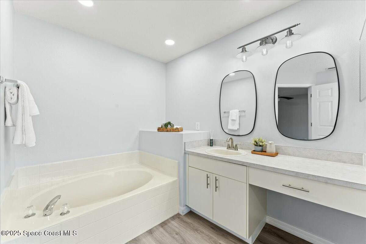 194 Saybrook Road Southwest Palm Bay, FL 32908 - Photo 24 of 35 a bathroom with a tub sink and mirror