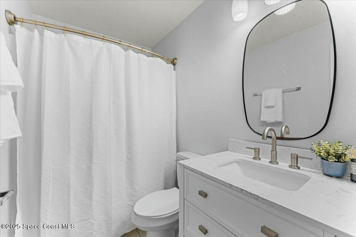 194 Saybrook Road Southwest Palm Bay, FL 32908 - Photo 26 of 35 a bathroom with a sink mirror and toilet