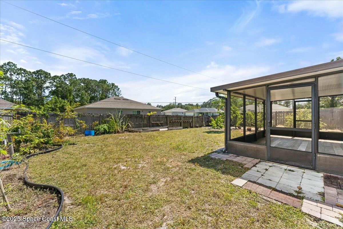 194 Saybrook Road Southwest Palm Bay, FL 32908 - Photo 28 of 35 a view of a house with backyard outdoor seating area and barbeque oven