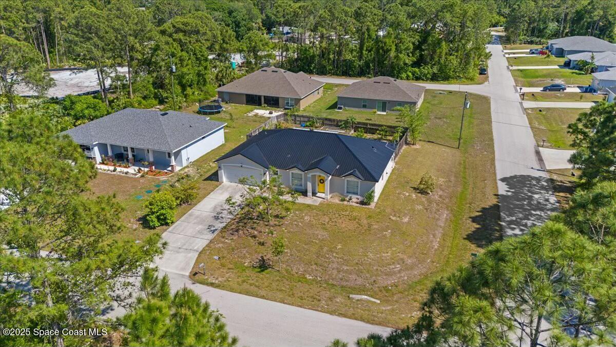 194 Saybrook Road Southwest Palm Bay, FL 32908 - Photo 32 of 35 an aerial view of a house with swimming pool and large trees
