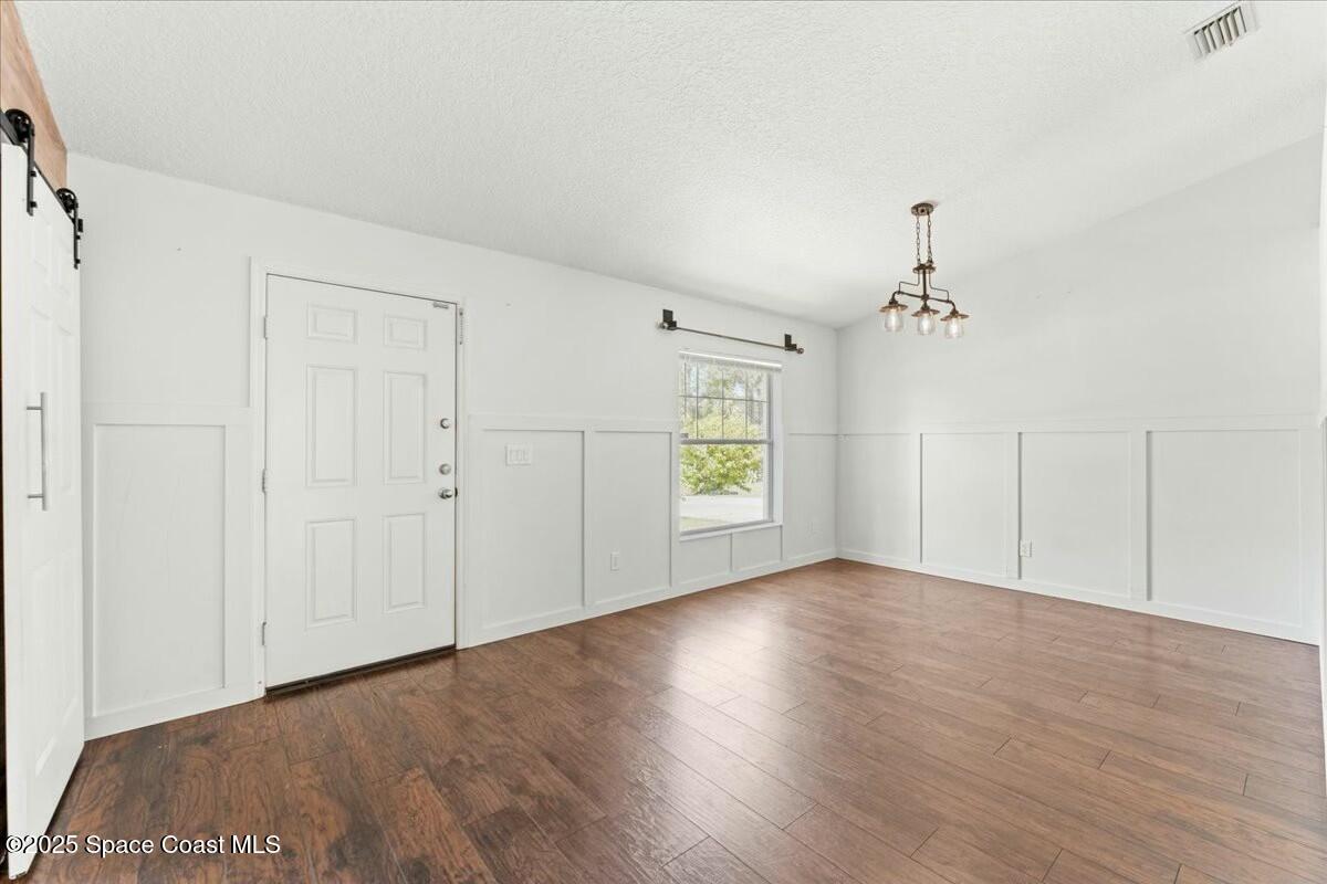 194 Saybrook Road Southwest Palm Bay, FL 32908 - Photo 4 of 35 a view of an empty room with wooden floor and a window