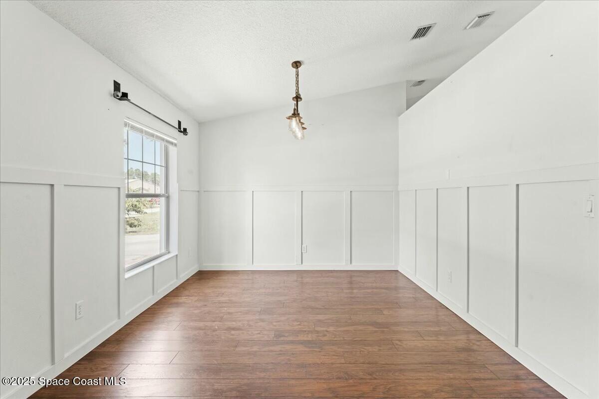 194 Saybrook Road Southwest Palm Bay, FL 32908 - Photo 5 of 35 a view of an empty room with window and wooden floor