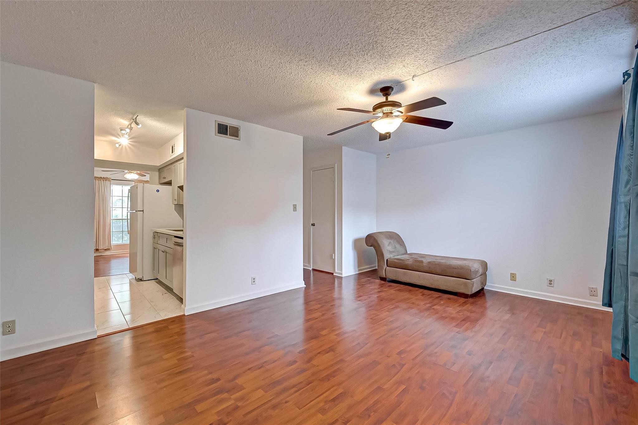 8101 Amelia Road, Unit 206 Houston, TX 77055 - Photo 11 of 32 a view of a room with wooden floor and a ceiling fan