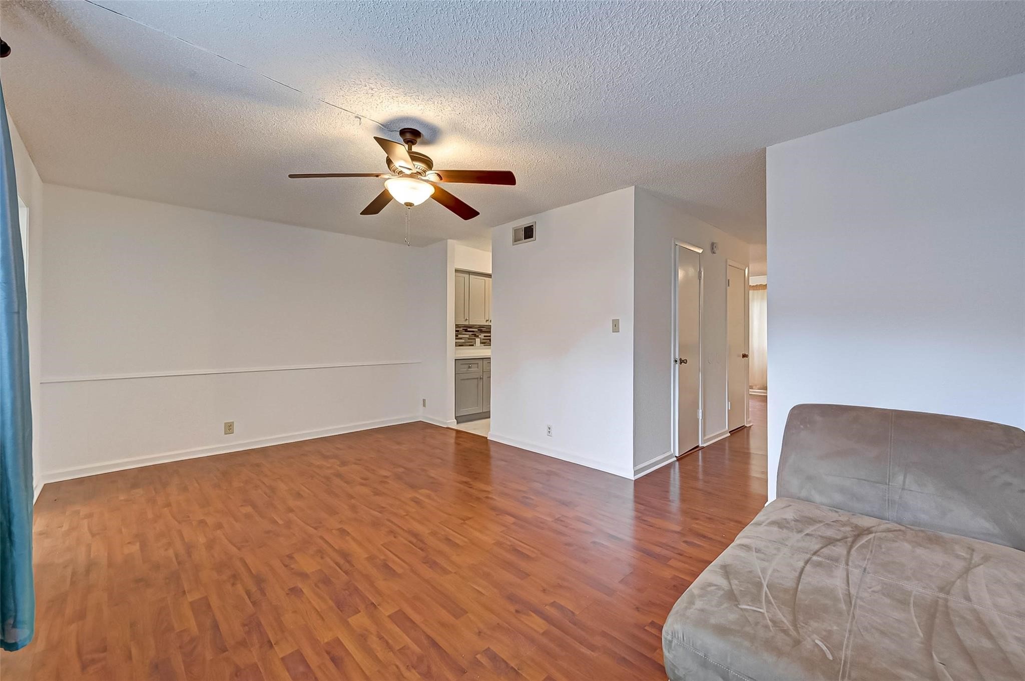 8101 Amelia Road, Unit 206 Houston, TX 77055 - Photo 12 of 32 a view of a big room with wooden floor and a ceiling fan