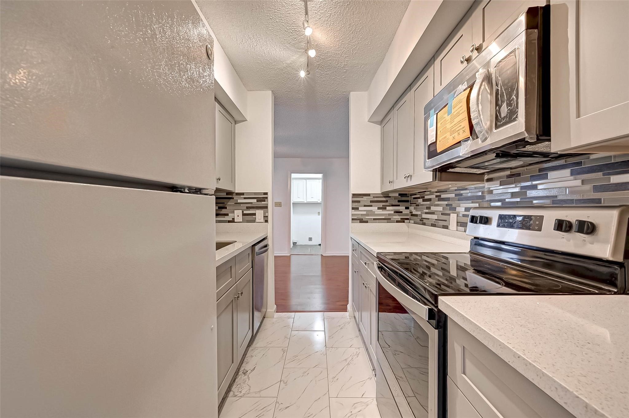 8101 Amelia Road, Unit 206 Houston, TX 77055 - Photo 13 of 32 a kitchen with a stove and a refrigerator