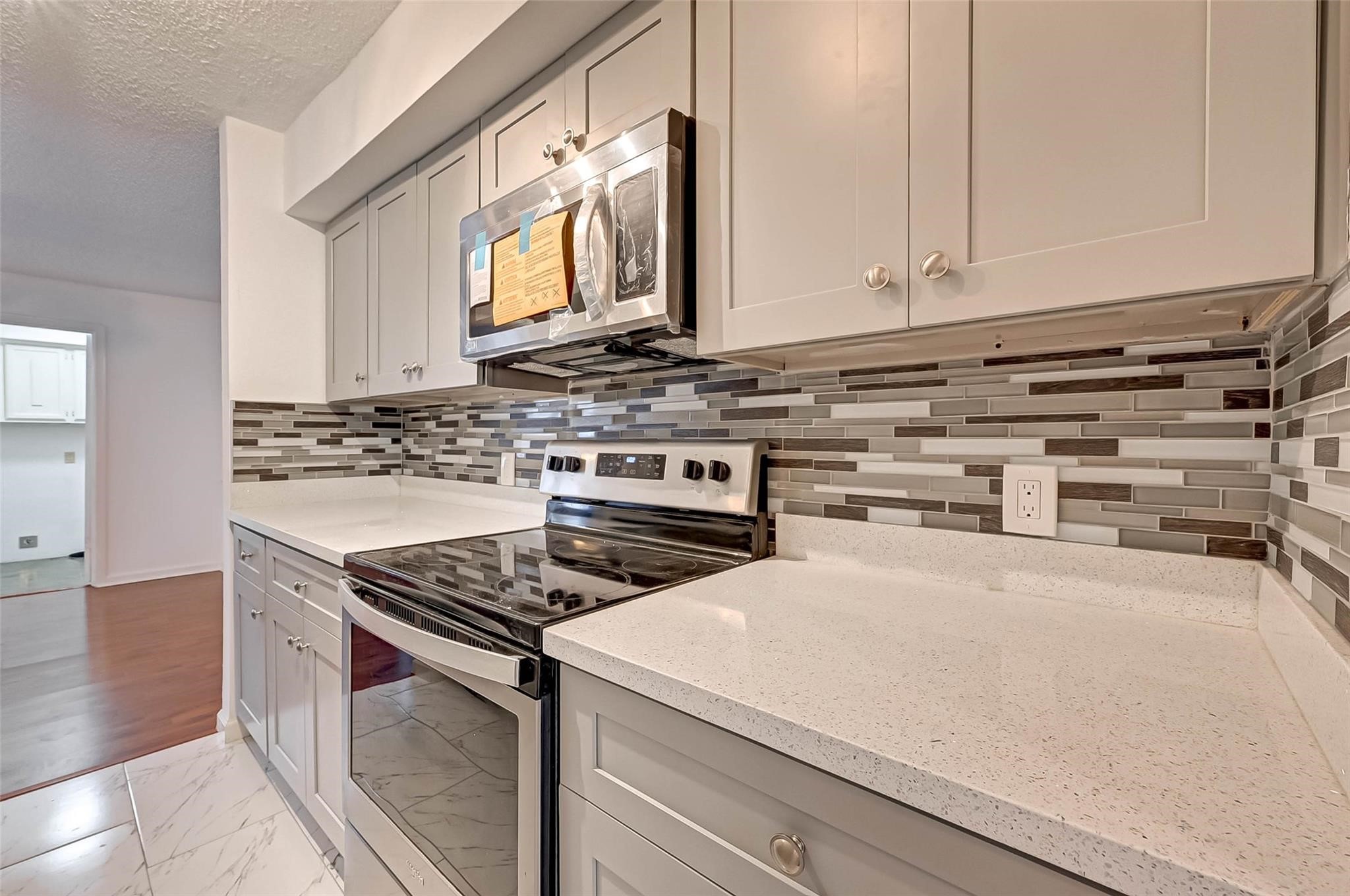8101 Amelia Road, Unit 206 Houston, TX 77055 - Photo 14 of 32 a kitchen with stainless steel appliances a stove a white cabinet and a granite counter tops