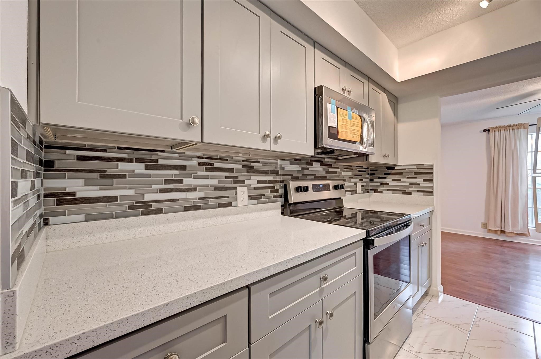 8101 Amelia Road, Unit 206 Houston, TX 77055 - Photo 17 of 32 a kitchen with a stove and a microwave