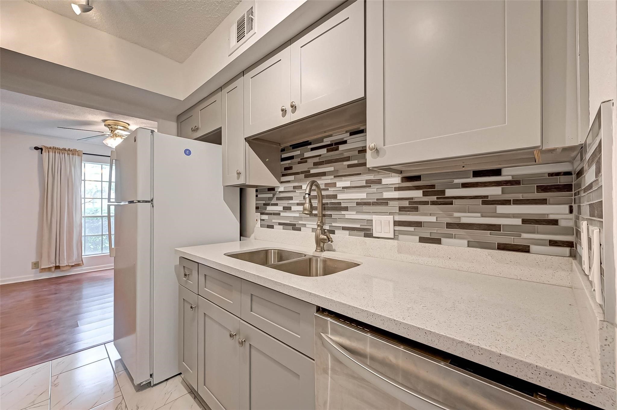 8101 Amelia Road, Unit 206 Houston, TX 77055 - Photo 18 of 32 a kitchen with a sink and a refrigerator