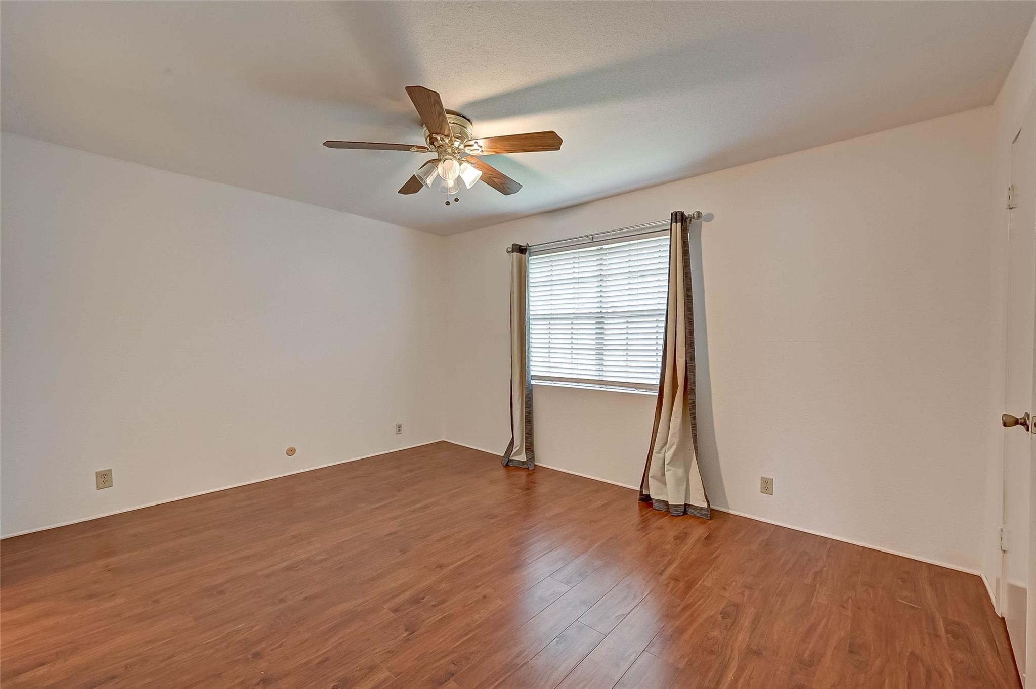 8101 Amelia Road, Unit 206 Houston, TX 77055 - Photo 23 of 32 an empty room with wooden floor fan and windows