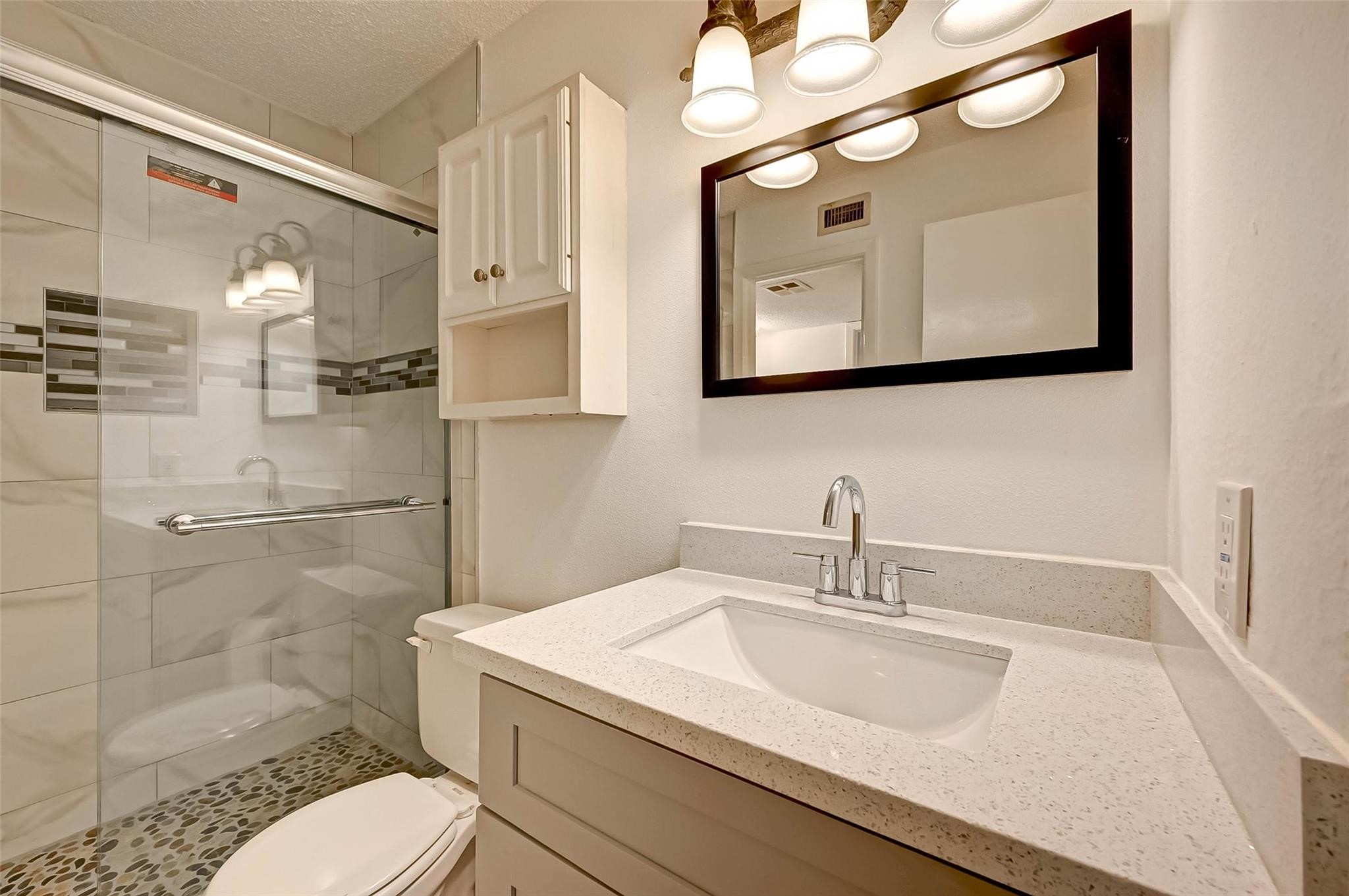 8101 Amelia Road, Unit 206 Houston, TX 77055 - Photo 27 of 32 a bathroom with a sink a toilet and shower