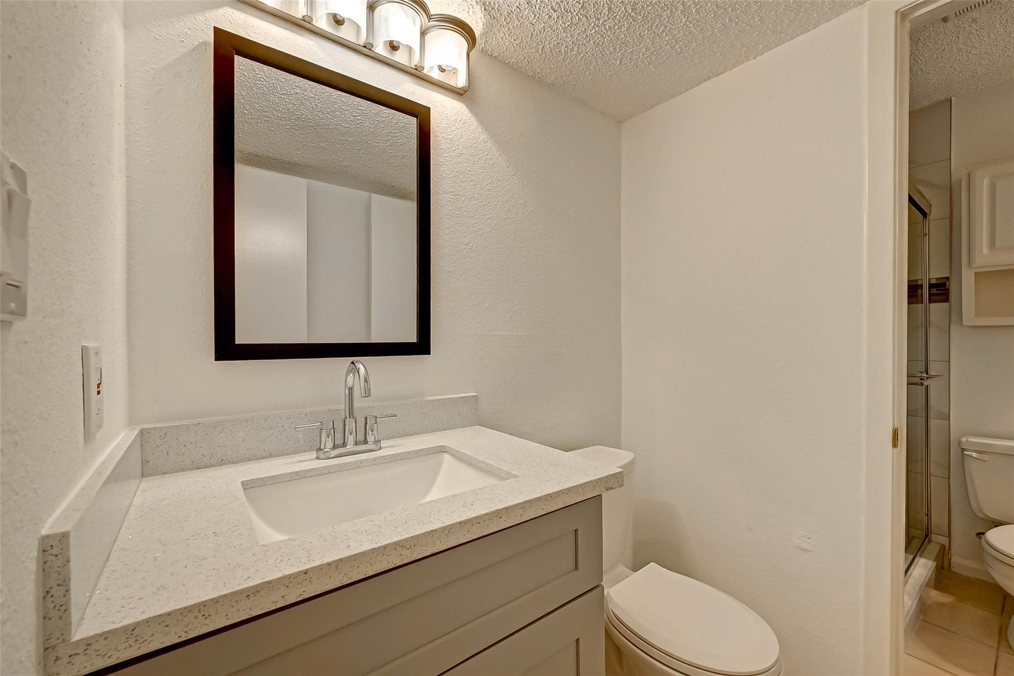 8101 Amelia Road, Unit 206 Houston, TX 77055 - Photo 30 of 32 a bathroom with a toilet sink and mirror