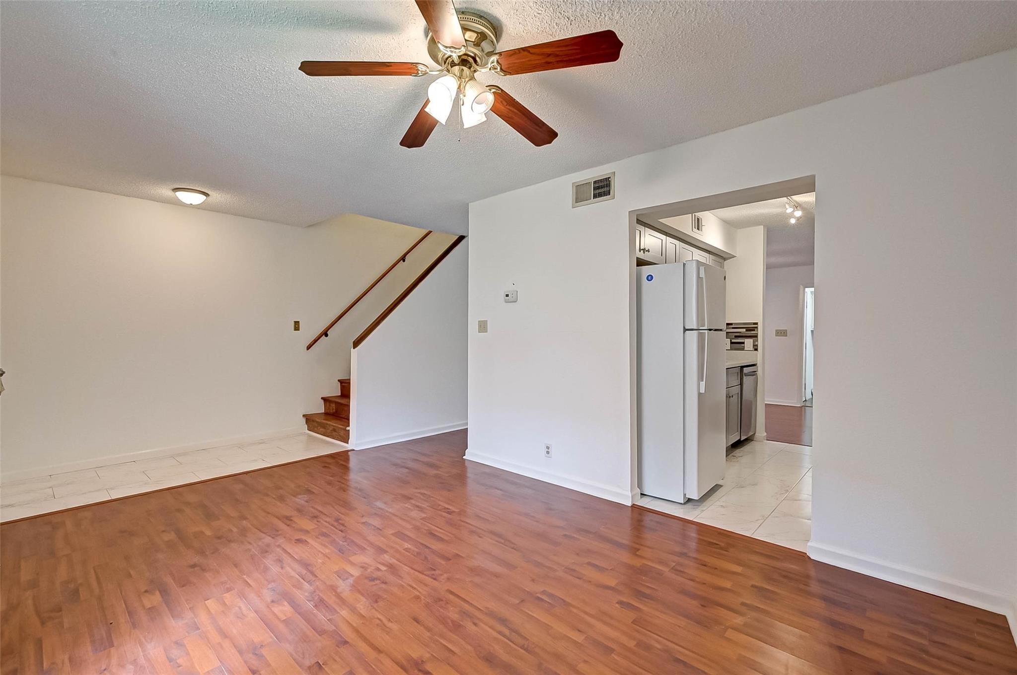 8101 Amelia Road, Unit 206 Houston, TX 77055 - Photo 8 of 32 wooden floor in an empty room with a chandelier fan