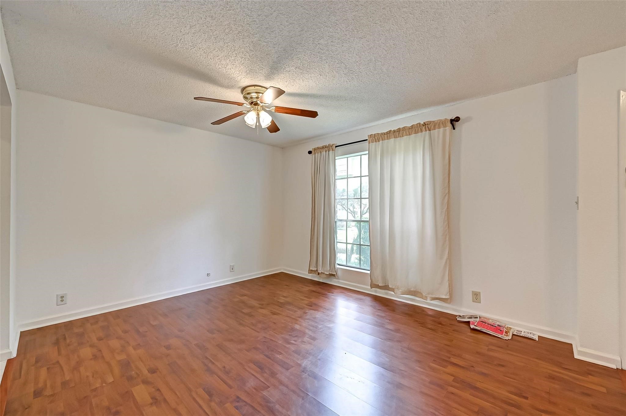 8101 Amelia Road, Unit 206 Houston, TX 77055 - Photo 9 of 32 a view of an empty room with a window and wooden floor