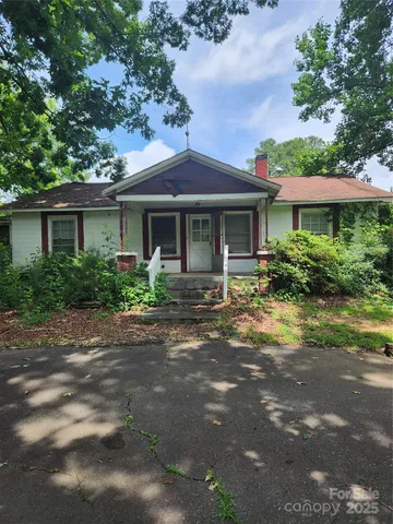 a front view of a house with yard and green space
