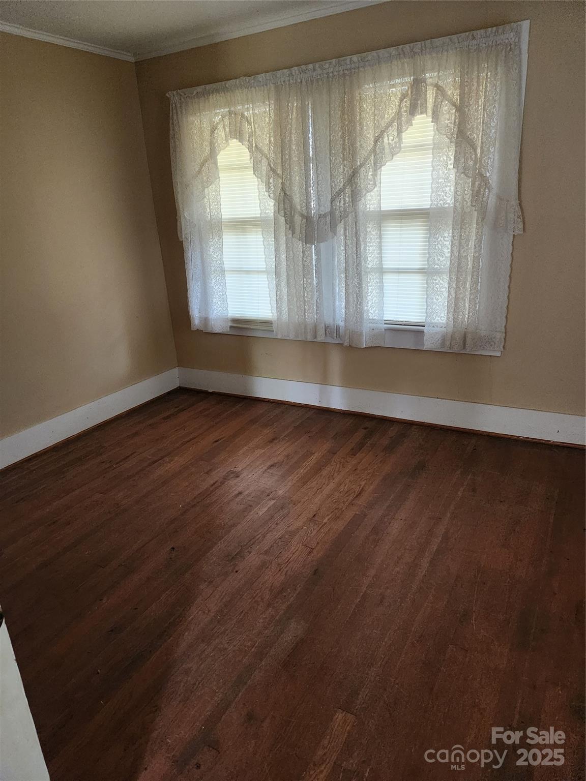 423 Tot Dellinger Road Cherryville, NC 28021 - Photo 7 of 14 an empty room with wooden floor and windows