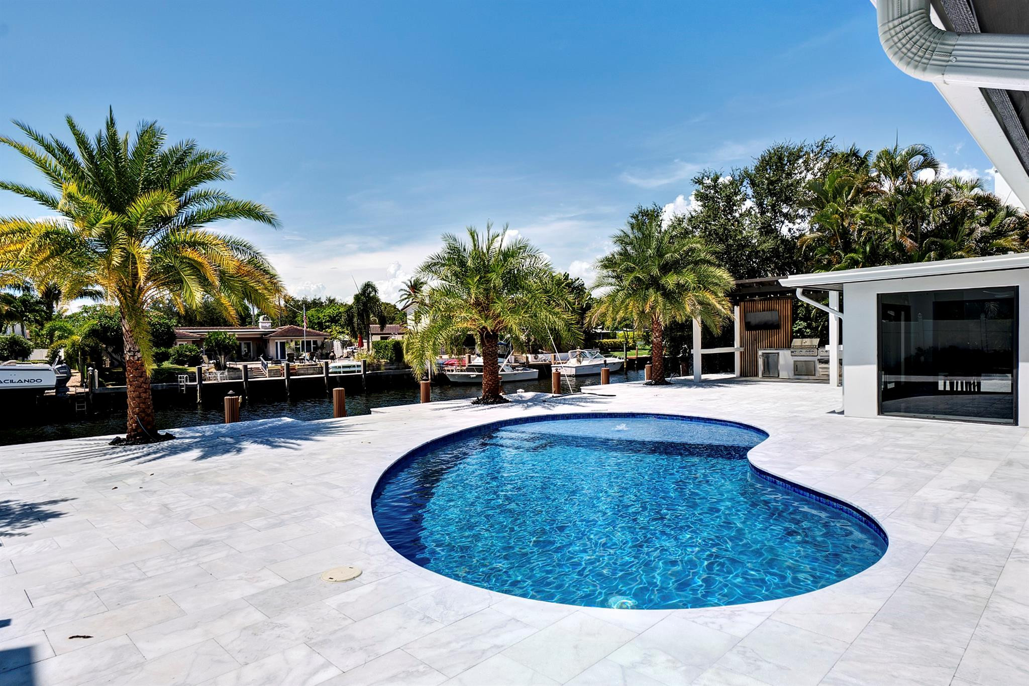 2310 Northeast 48th Court Lighthouse Point, FL 33064 - Photo 1 of 61 a swimming pool with outdoor seating and yard