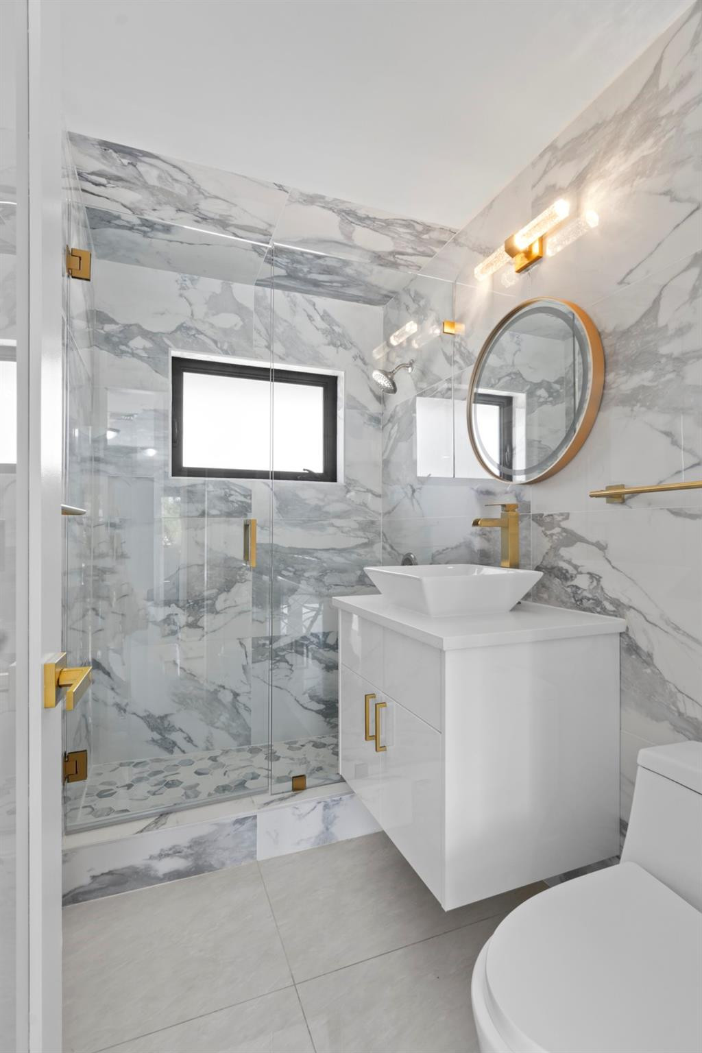 2310 Northeast 48th Court Lighthouse Point, FL 33064 - Photo 26 of 61 a bathroom with a toilet a sink and mirror