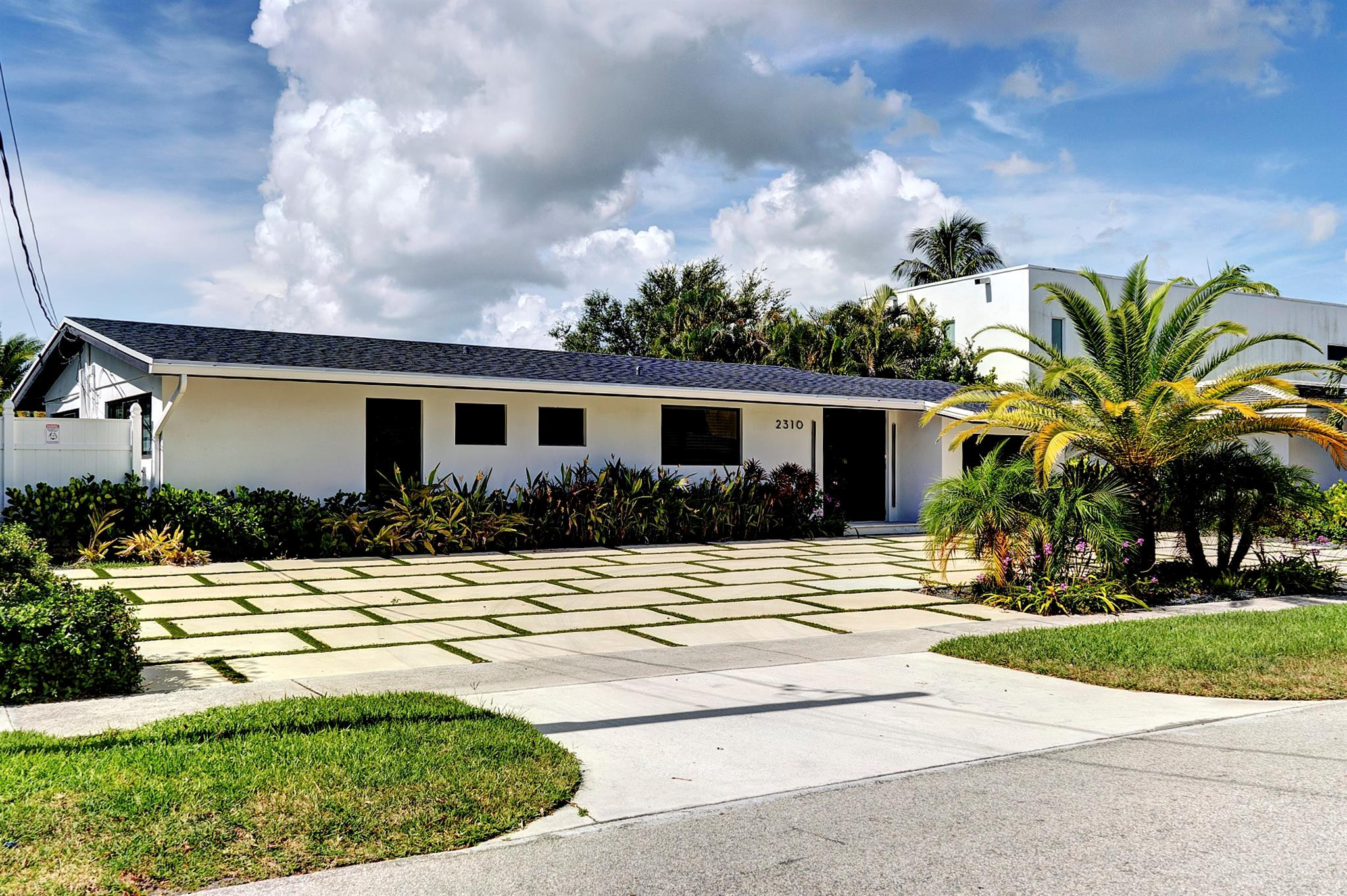 2310 Northeast 48th Court Lighthouse Point, FL 33064 - Photo 37 of 61 a view of a house with a swimming pool and a yard