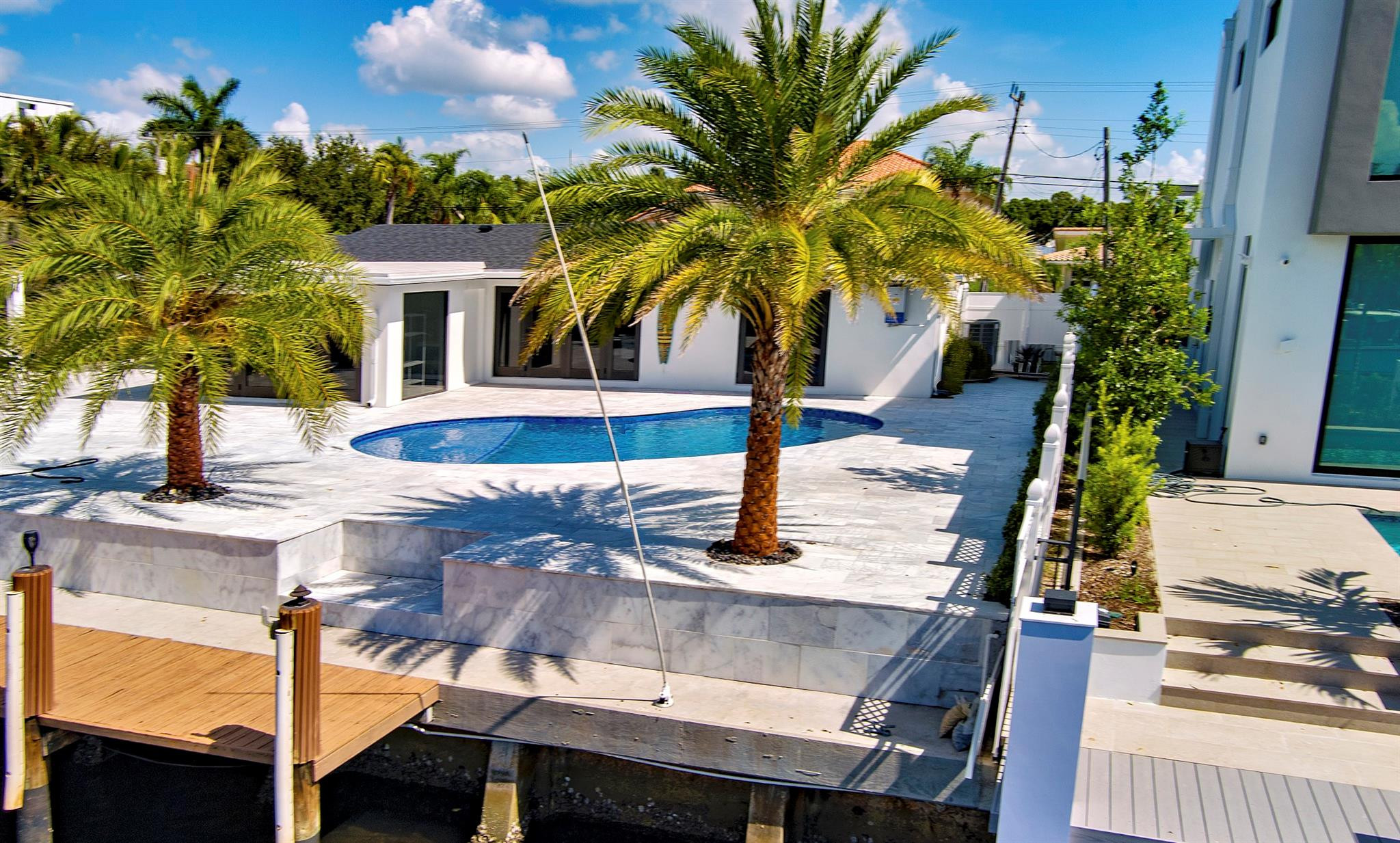 2310 Northeast 48th Court Lighthouse Point, FL 33064 - Photo 54 of 61 a view of a house with backyard and a patio