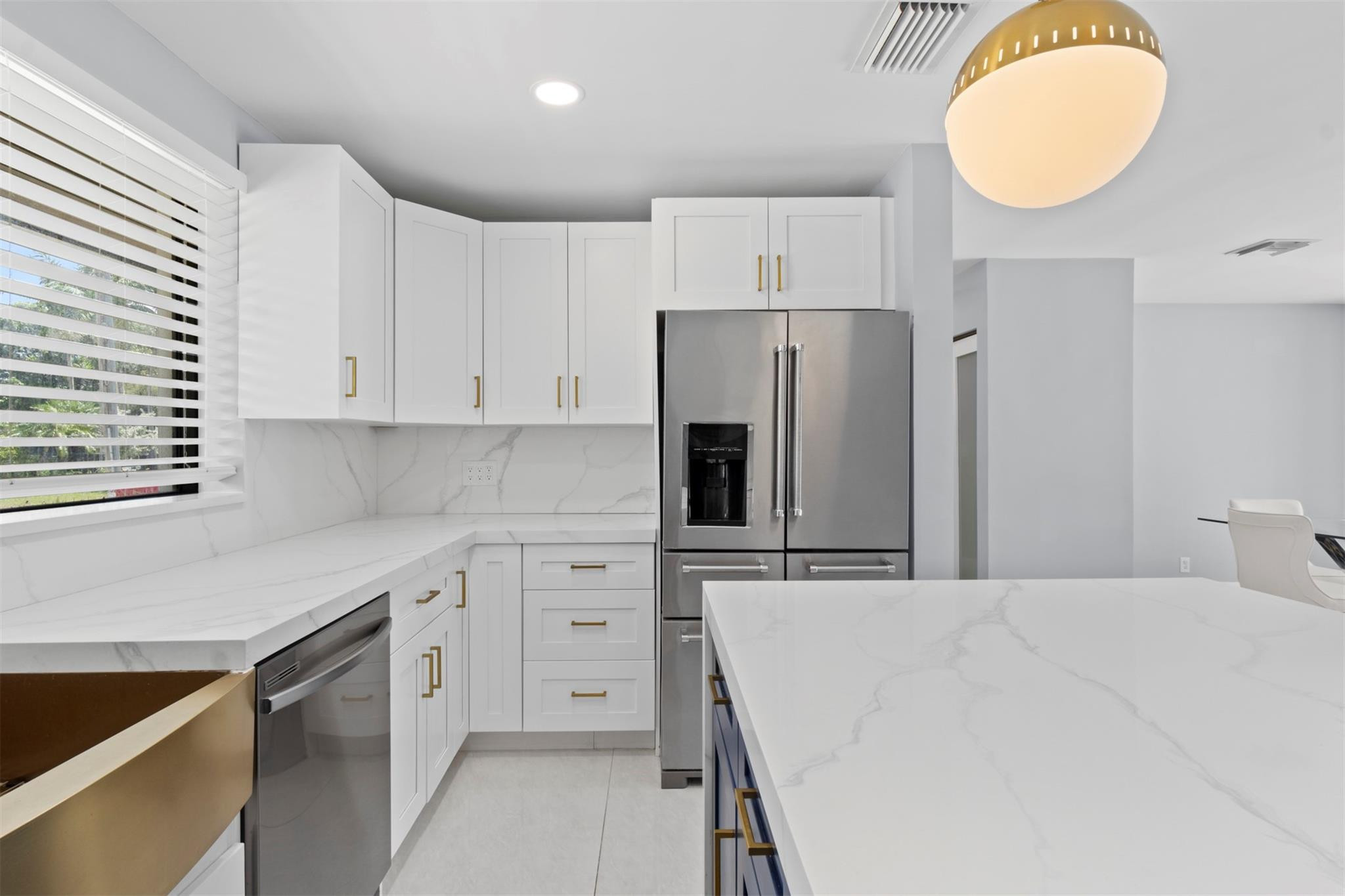 2310 Northeast 48th Court Lighthouse Point, FL 33064 - Photo 6 of 61 a kitchen with stainless steel appliances a refrigerator sink and cabinets