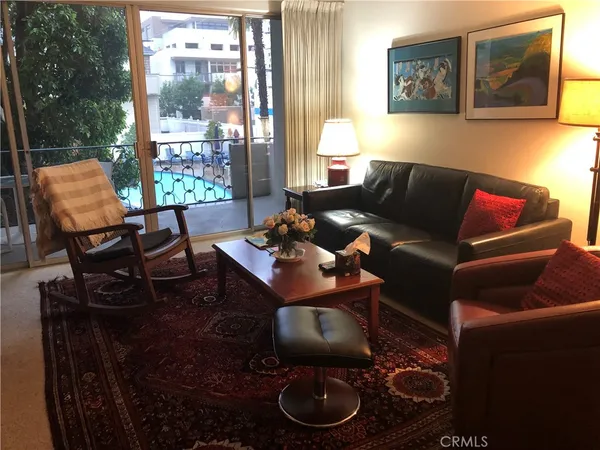 a view of a livingroom with furniture and a flat screen tv