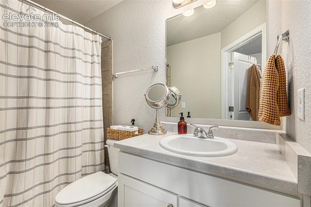 2940 Magic Carpet Loop Colorado Springs, CO 80916 - Photo 15 of 21 a bathroom with a sink toilet and shower