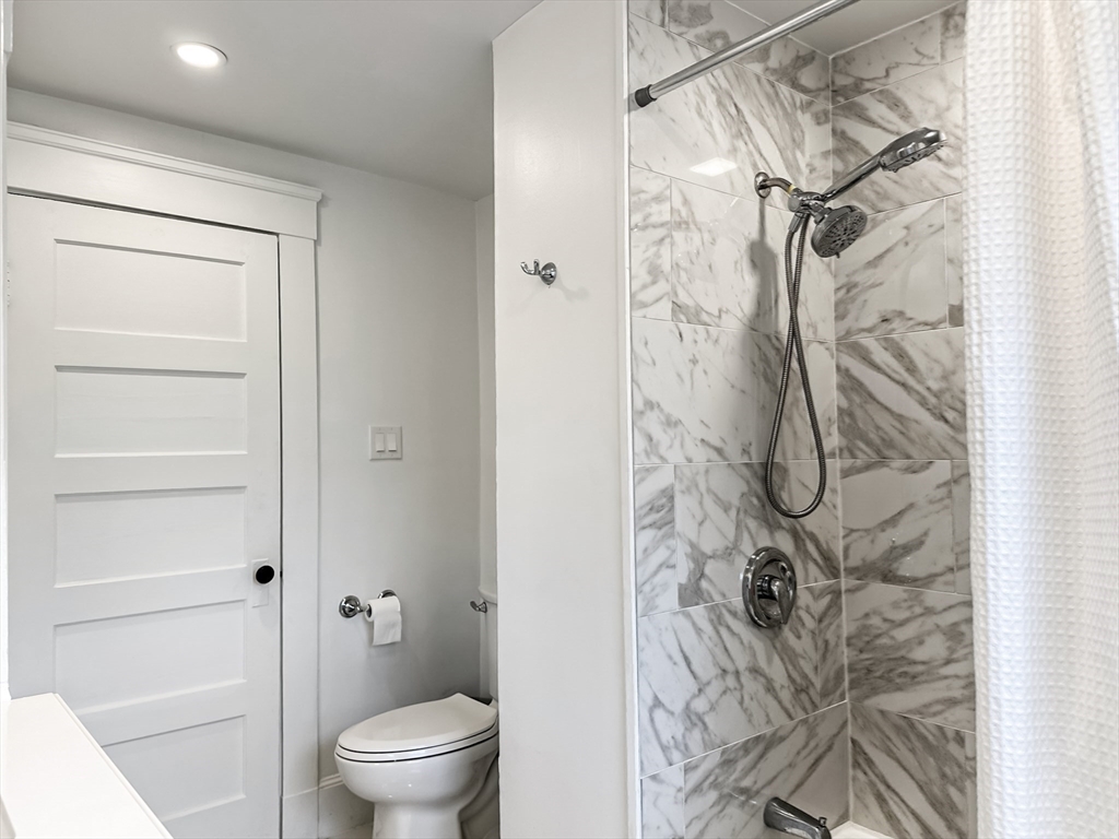24 York Street Andover, MA 01810 - Photo 14 of 34 a bathroom with a shower and a toilet