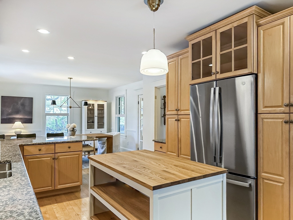 24 York Street Andover, MA 01810 - Photo 6 of 34 a kitchen with stainless steel appliances granite countertop a refrigerator a sink a stove and a wooden floors