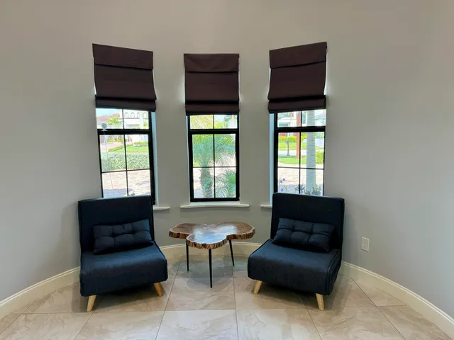a living room with couches and a large window with outer view
