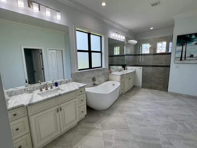 a bathroom with a granite countertop sink mirror bathtub and toilet