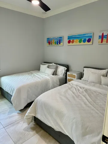 a bedroom with two beds and a couch