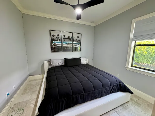 a bedroom with a large bed and a window