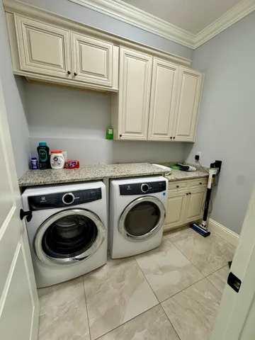 a utility room with sink dryer and washer
