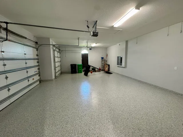 an empty room with furniture and a ceiling fan
