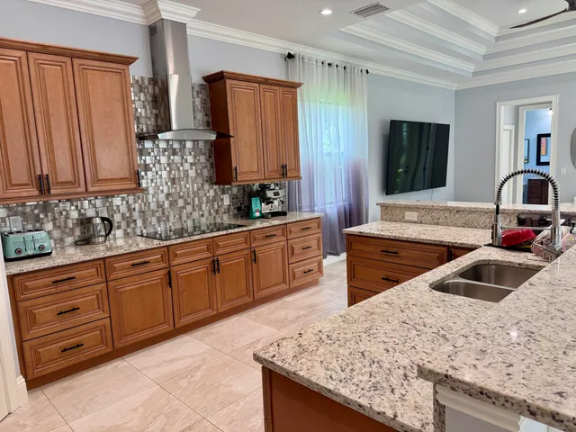 a kitchen with stainless steel appliances granite countertop a sink stove and refrigerator