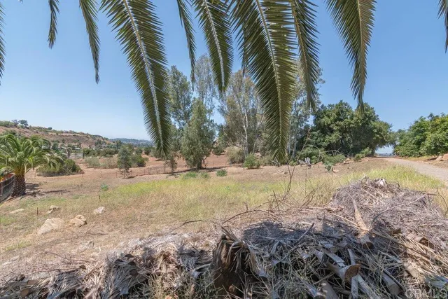 a view of a patio with table and chairs with wooden floor and fence