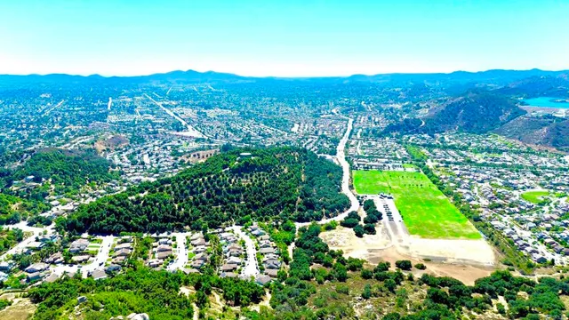 an aerial view of residential house with green space