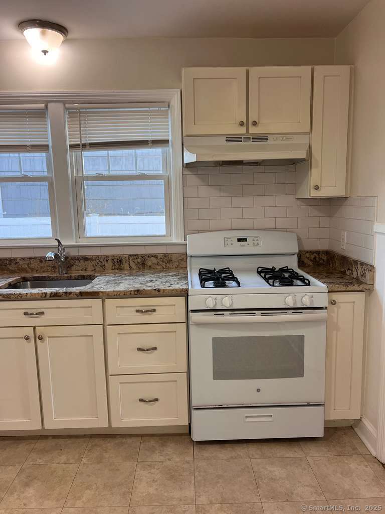 109 Alfred Street Bridgeport, CT 06605 - Photo 11 of 22 a stove top oven sitting inside of a kitchen
