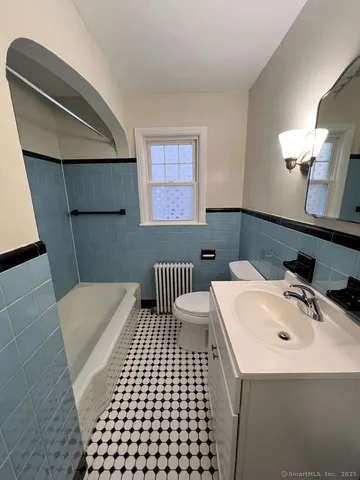 a bathroom with a sink a toilet and mirror