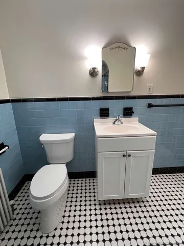 a bathroom with a sink toilet and mirror