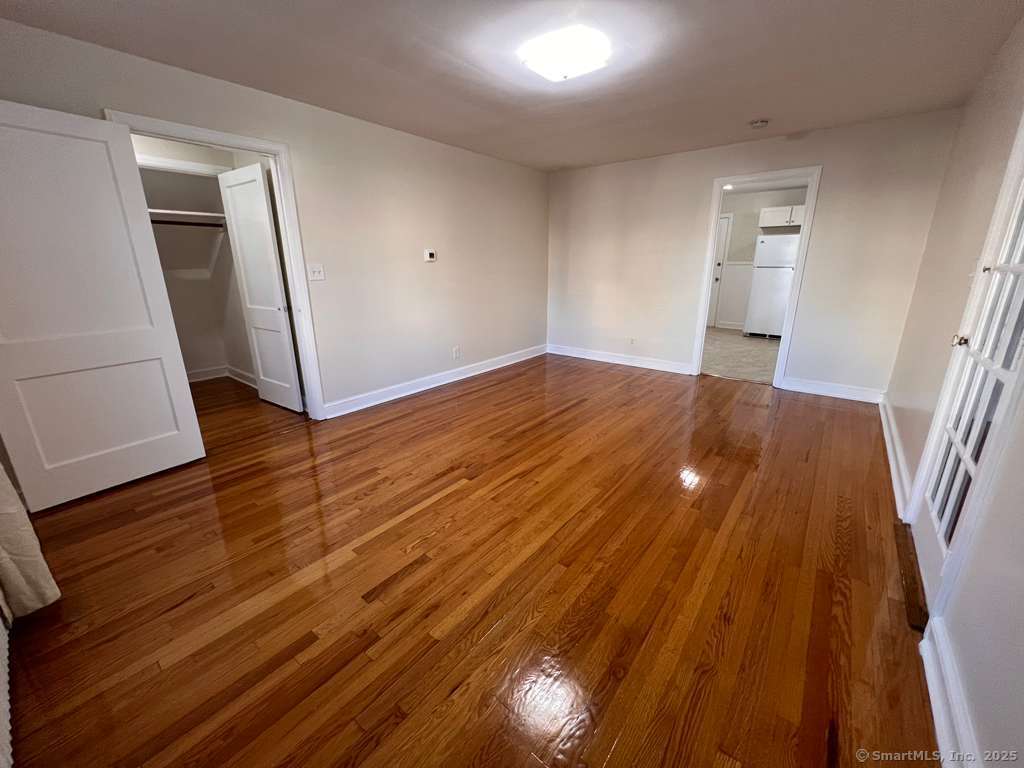 109 Alfred Street Bridgeport, CT 06605 - Photo 5 of 22 wooden floor in an empty room with a mirror