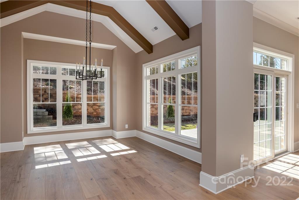 811 Naples Drive Davidson, NC 28036 - Photo 12 of 31 a view of an empty room with wooden floor and a window