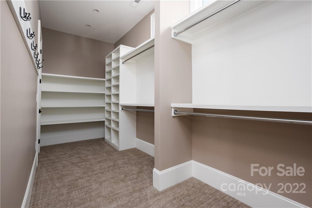 811 Naples Drive Davidson, NC 28036 - Photo 16 of 31 a view of walk in closet with empty racks